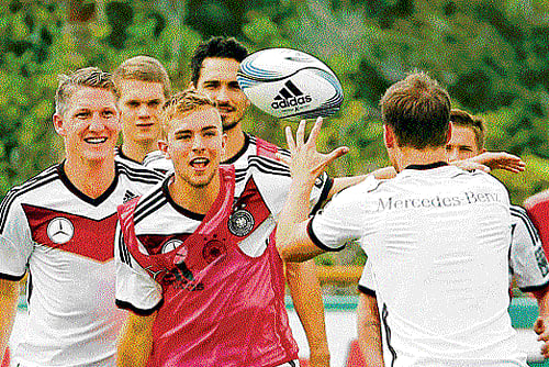 different ball game: German team members try their hand in rugby during a training session on Wednesday ahead of their World Cup Group G match against USA. reuters
