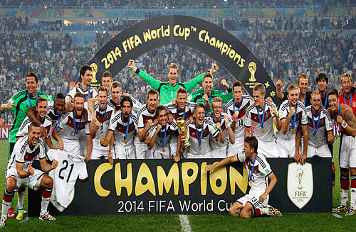 German players celebrate with the trophy after the World Cup final soccer match between Germany and Argentina at the Maracana Stadium in Rio de Janeiro, Brazil, AP photo