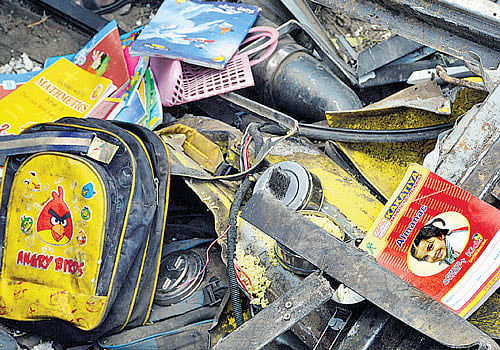 A relative of a victim cries at the site of the train crash. Heaps of the students' school books and stationery lay strewn along the track. AP photo