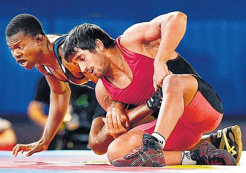 Firm grip: India's Bijneesh Bajrang (right) wrestles Nigeria's Amas Daniel during their freestyle 61kg semifinal on Wednesday. pti