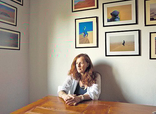 Mariasandra Mariani, an Italian tourist who was kidnapped in Algeria in 2011 and held for 14 months, is surrounded by photos from earlier trips to the Sahara at her family home in San Casciano in Val di Pesa. NYT Photo