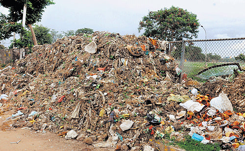 messy The silt and plastic from the storm water drain near the lake dumped on the road. DH Photos by SK Dinesh