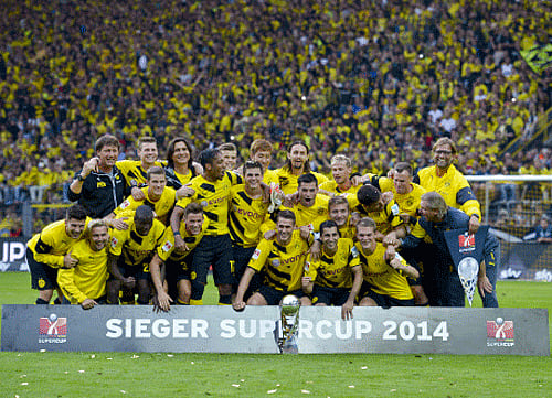 Dortmund players celebrate their 2-0 win in the German soccer Super Cup match between Borussia Dortmund and Bayern Munich in Dortmund, Germany. AP photo