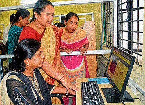 Officials inspect computers ahead of online trading in Mandya, on Thursday. DH photo