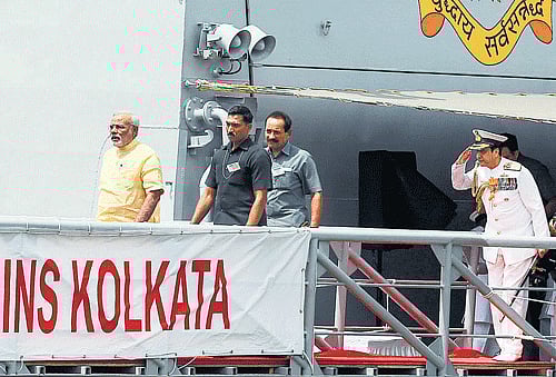 Prime Minister Narendra Modi walks down the gangplank of the INS Kolkata after its commissioning ceremony at a naval base in Mumbai. Reuters photo