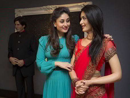Bollywood star Kareena Kapoor comes faces to face with her wax figure from 2011 after donating a new red sari with a gold trim that the actress wore from the film 'Ra.One', at Madame Tussauds in central London, England, Monday, Aug. 18, 2014. AP photo