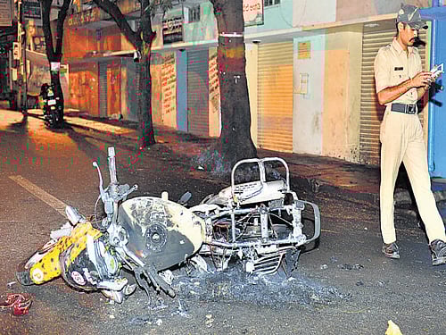 A police motorbike that was set ablaze by relatives and friends of Pradeep in Bangalore on Saturday night. DH photo/ Ranju P