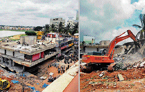 off with them: The Palike's demolition squad brought down buildings constructed illegally on the Dasarahalli lake bed on Monday. dh photos