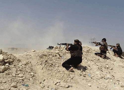 Tribal fighters fire their weapons during an intensive security deployment to fight against militants of the Islamic State. Reuters file photo