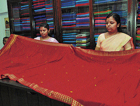 spoilt for choice: One of the old silk sarees being exhibited by the showroom staff in Mysore. dh Photo