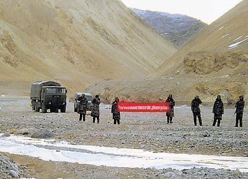 In this May 5, 2013 photo, Chinese troops hold a banner which reads ''You've crossed the border, please go back'' in Ladakh. AP file Photo