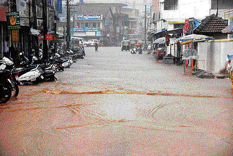 battered: Roads were flooded in Hassan following heavy rain on Wednesday. dh Photo