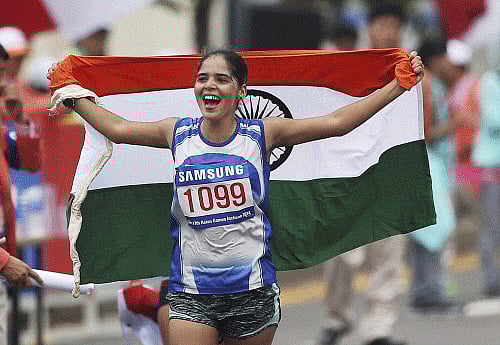 India's Khushbir Kaur holds the tricolour after finishing second in the women's 20km race walk at the 17th Asian Games in Incheon on Sunday. PTI Photo
