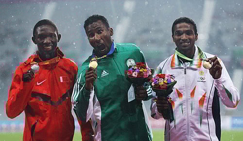 in elite company: Arokia Rajiv (right) with gold medallist Yusuf Masrahi of Saudi Arabia (centre) and Abbas Abubaker Abbas of Bahrain after the 400M final. Reuters