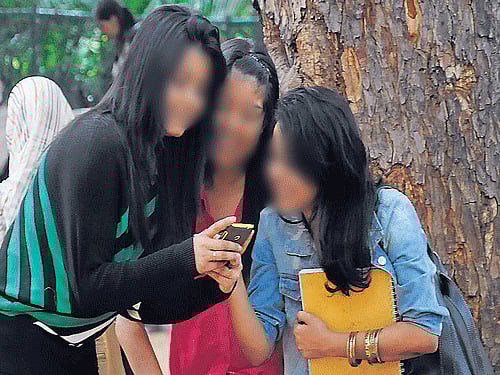 addicted Youngsters who spend more time on social media have less time to spend with real people. DH Photo For Representation