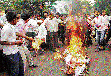 PROTEST GONE AWRY The dhoti of an elderly person caught fire while burning an effigy during a protest in Bidar on Saturday. DH photo