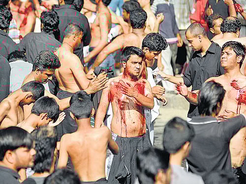 Shia Muslims flagellate themselves during the Muharramprocession onHosur Road near Johnson Market in the City on Tuesday. DH PHOTO