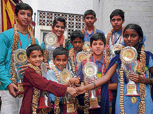 Hoysala & Keladi Chennamma Bravery Award winners (from left front row) Sumithkumar Sindagi, Deekshith G P, B Appu, K R Anoop, K M Shanthi, (back row from left) K R Swaroop, Poornima Edave, Kishan G K and R Sahanesh greet each other after receiving awards at the Children's Day celebration in Bengaluru on Friday. DH Photo