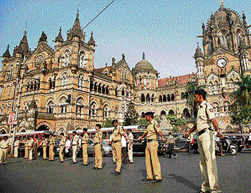 On vigil: Policemen stand guard outside the Chhatrapati Shivaji train station, one of the sites of the 2008 terror attack, in Mumbai on Wednesday. AP