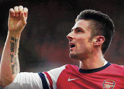 Arsenal held their nerve, their lead and their record of reaching the Champions League knockout stages when they beat Borussia Dortmund 2-0 on Wednesday . AP file photo