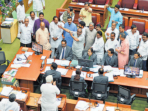 BJP members stage a dharna in thewell of the Legislative Assembly, seeking tomove an adjournmentmotion on sugar cane farmers' problems on the first day of the winter session of the Legislature at the Suvarna Soudha in Belagavi on Tuesday. DH PHOTO