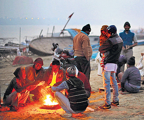People keep warm around a bonfire on the banks of the Ganga in Allahabad, Uttar Pradesh, on Saturday. AP Image . AP
