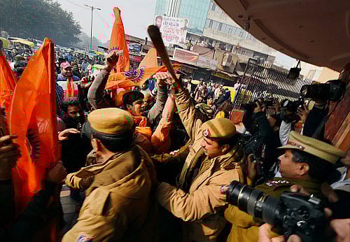 Right wing activists protesting against Aamir Khan starrer 'PK' clash with police outside a movie theatre, in New Delhi on Tuesday. PTI Photo