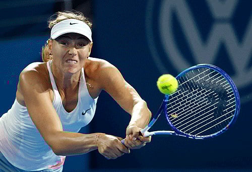 Maria Sharapova of Russia plays a backhand return to Yaroslava Shvedova of Kazakhstan during their women's singles second round match at the Brisbane International tennis tournament in Brisbane. Photo: Reuters