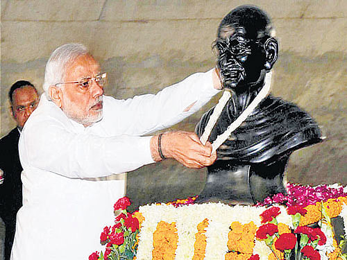 In Gandhi's Nagar: Prime Minister Narendra Modi garlands the statue of Mahatma Gandhi at the Mahatma Gandhi Temple during the 13th edition of the 'Pravasi Bharatiya Divas' in Gandhinagar, Gujarat, on Thursday. PTI
