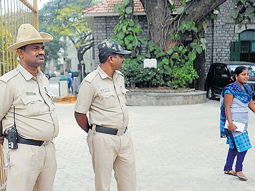 Police stand guard in front of the Bishop Cotton Girls' School on Thursday after many students staged a protest against the management's decision to replace the principal. DH photo