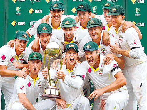 cup is ours: Australian players pose with the Border-Gavaskar Trophy at the SCG on Saturday. reuters