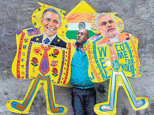 A kite-maker poses with kites depicting US President Barack Obama and Prime Minister Narendra Modi in Amritsar on Wednesday. AFP
