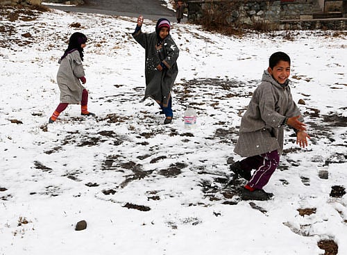 Kashmiri children play in the snow after fresh snowfall on the outskirts of Srinagar. AP photo