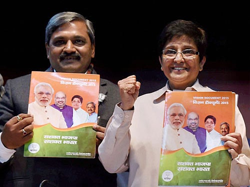 Delhi BJP President Satish Upadhyay with BJP CM candidate Kiran Bedi releasing party's Vision Document for Delhi Assembly election 2015, in New Delhi on Tuesday. PTI Photo
