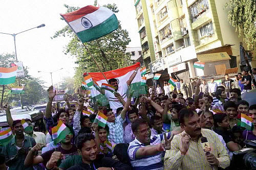 Cricket fans celebrate after India won their first match against Pakistan in ICC Cricket World Cup-2015, in Thane, Maharashtra on Sunday. PTI Photo