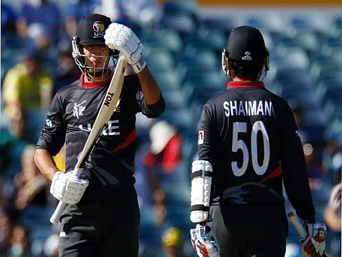 UAE's Rohan Mustafa walks off the pitch past his team mate Shaiman Anwar after being dismissed LBW off the bowling of India's bowler Mohit Sharma during their Cricket World Cup match in Perth. Reuters Photo