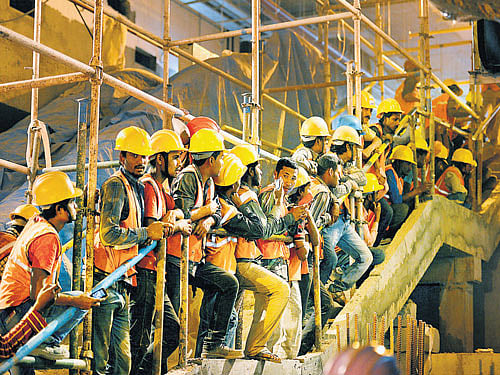 Namma Metro workers anxiously watch the train enter the Cubbon Park underground  station on Thursday. DH photo/Anand bakshi