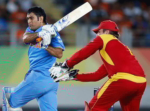 India's Dhoni hits a six watched by Zimbabwe's Taylor during their Cricket World Cup match at Eden Park in Auckland. Reuters file photo