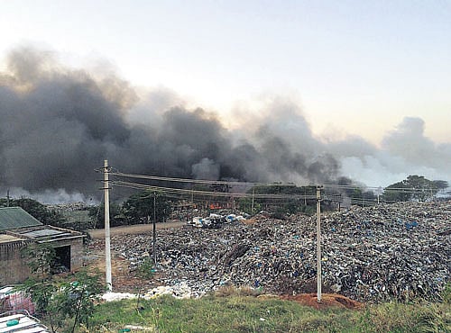 DANGEROUS: Plumes of thick smoke engulf the area around the Terra Firmalandfill nearDoddaballapur on Friday. DH PHOTO