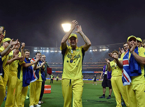 Australian players clap for their captain Michael Clarke (C), who announced his retirement from one-day international cricket on the eve of the final, after they defeated New Zealand in the 2015 Cricket World Cup final. AFP photo