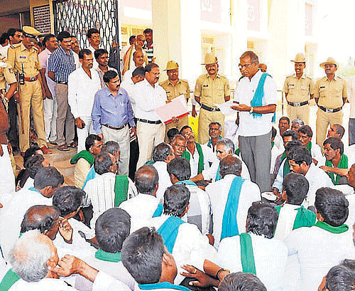 Members of Raitha Sangha stage a protest near Taluk Office, in Chamarajanagar, on Monday. DH PHOTO
