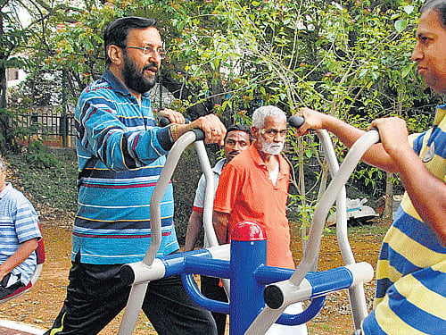 health is wealth: Prakash Javadekar, Union Minister of State for Environment and Forests, tries the fitness equipment at Sankey tank on Saturday. dh photo
