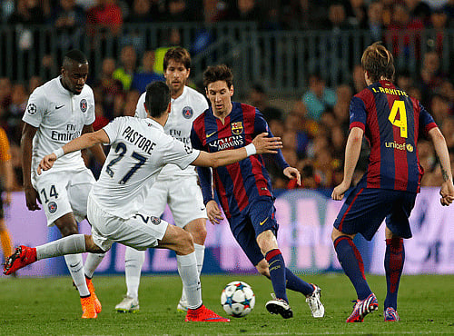 Barcelona's Lionel Messi, second right, takes on the PSG defence during the Champions League quarterfinal second leg soccer match between FC Barcelona and Paris Saint Germain. AP photo