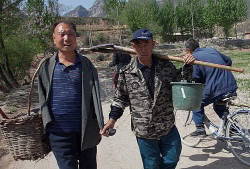 Jia Wenqi, left, and Jia Haixia, right, walk along a lane in Yeli village near Shijiazhuang city in northern China's Hebei province. Photo: AP