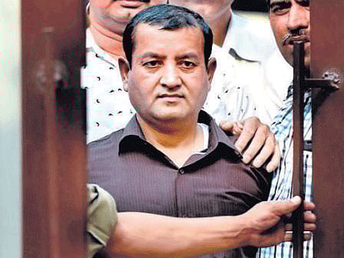 IM operative Irfan being  produced before the media in New Delhi on Monday. PTI