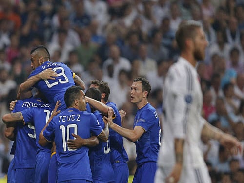 Juventus players celebrate after Alvaro Morata, scored during the Champions League second leg semifinal soccer match between Real Madrid and Juventus, at the Santiago Bernabeu stadium in Madrid. AP photo