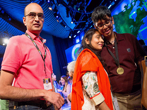Karan Menon of New Jersey, right, is greeted on stage by his parents Rakesh, left, and Manisha, center, after he won the National Geographic Bee, Wednesday, May 13, 2015, at the National Geographic Society in Washington. AP Photo