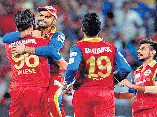well done, mate!: Royal Challengers' captain Virat Kohli congratulates David Wiese for dismissing Rajasthan Royals' Steve Smith in the Indian Premier League Eliminator in Pune on Wednesday. pti