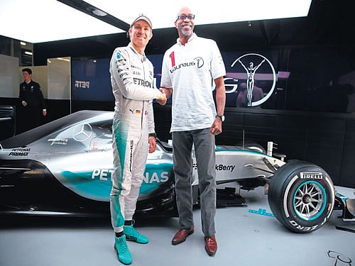 fuelling change: Former Olympic champ and Laureus Sport for Good Foundation Chairman Edwin Moses with F1 ace Nico Rosberg. Clive Mason/Getty Images for Laureus