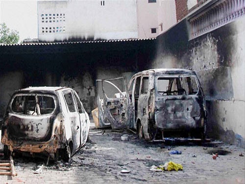 Damaged vehicles after clash between two communities at village Atali in Faridabad. PTI photo